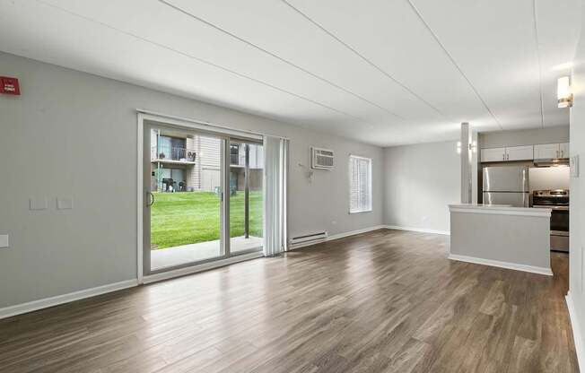 A spacious room with wooden flooring and a reception desk.