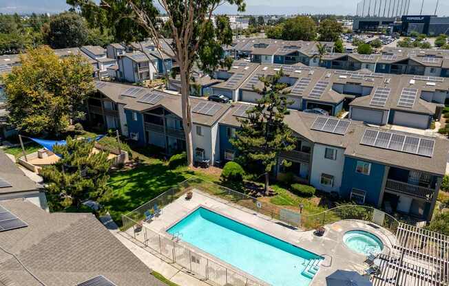 Apartment complex with a pool and solar panels.