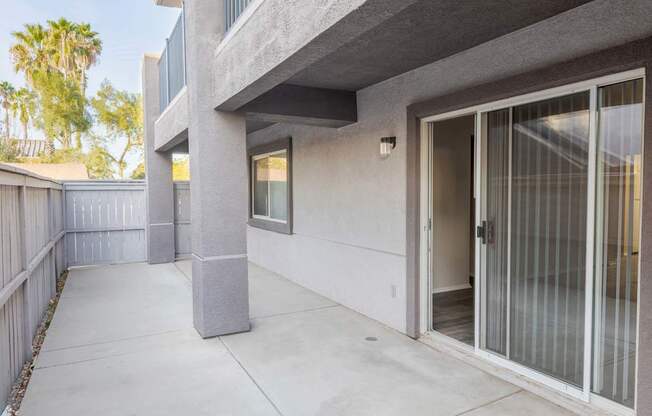 the patio of a condo building with a glass door