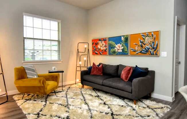 a living room with a couch and a ceiling fan