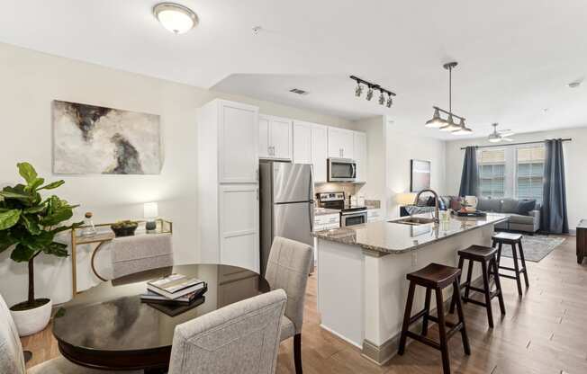 a living room with a kitchen and a dining table