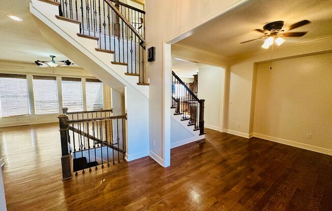 {20067} Custom Built Home in Woodland Manor + Open Main Level with Modern Lighting and Hardwood Flooring + Finished Walk Out Basement + Enclosed Sunroom + Three Car Garage + Fenced Yard