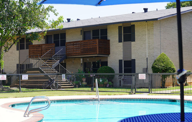 a swimming pool in front of an apartment building