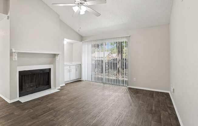 a living room with a fireplace and a large window