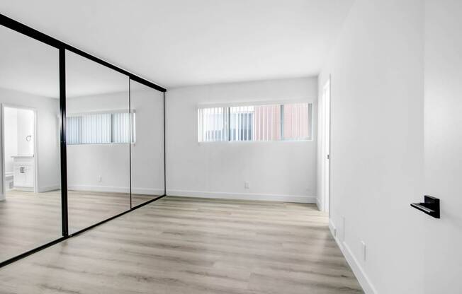 an empty room with white walls and a glass door