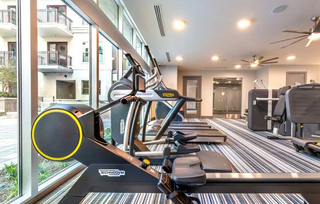 Fitness center area facing a stair climber and exterior windows