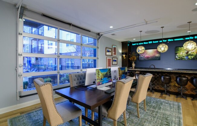 A dining room with a table and chairs and a view of a balcony.