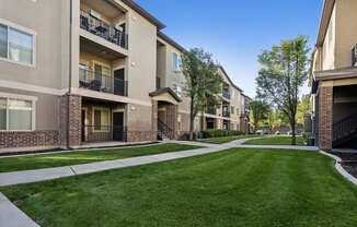 our apartments have a spacious courtyard with green grass and trees