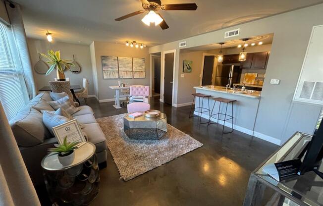 a living room and kitchen with a ceiling fan at Palisades at Pleasant Crossing, Rogers, AR 72758