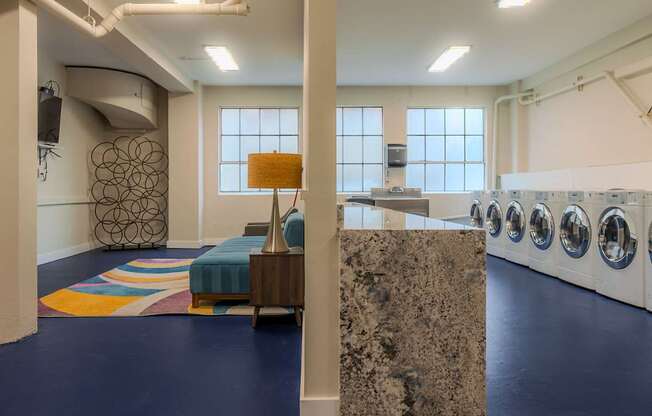 A laundry room with a washer and dryer section.