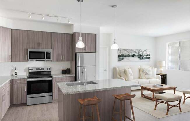 A modern kitchen with a large island and a dining area.