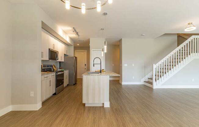 A kitchen with a white island in the middle of the room.