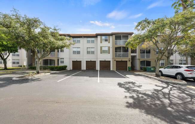 an empty parking lot in front of an apartment building
