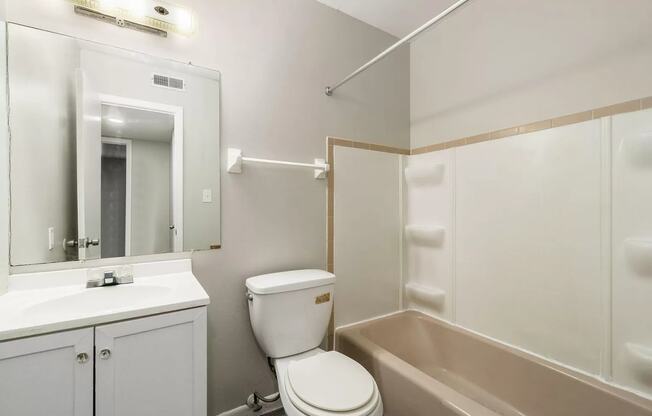 a bathroom with a toilet and a sink and a bath tub
