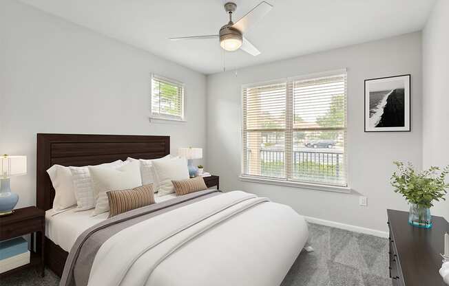 a bedroom with a large bed and two windows Two Addison Place, Pooler GA
