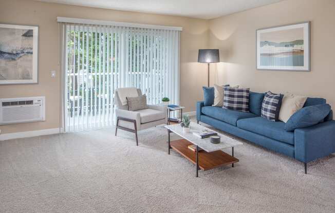 a living room with a blue couch and a coffee table