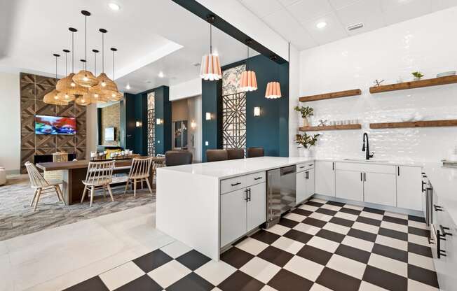 a kitchen with white cabinets and a checkered floor