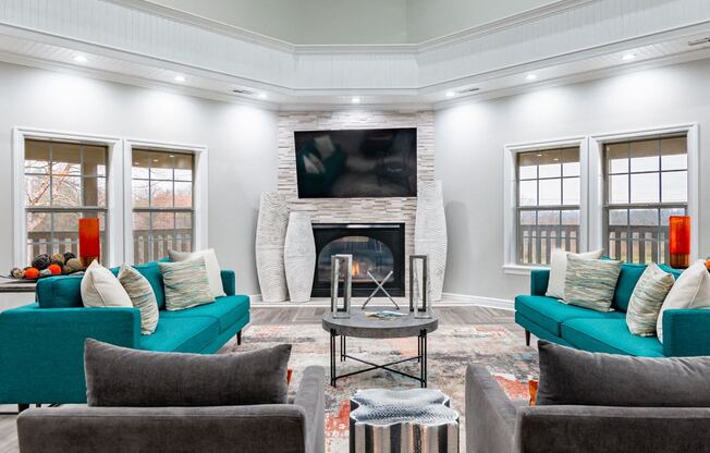 a living room with blue couches and a fireplace