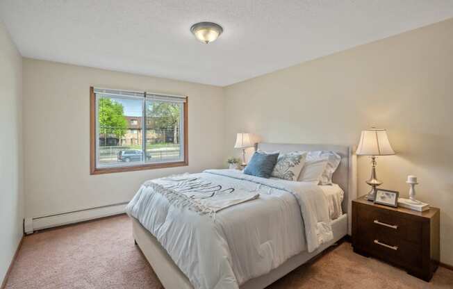 a bedroom with a large bed and a large window