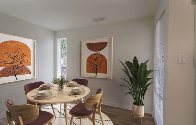 A dining room with a round table and chairs.