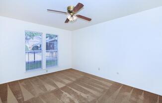 carpeted bedroom with a ceiling fan