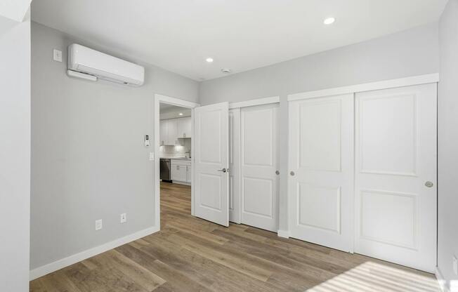 A room with a white door and a window.