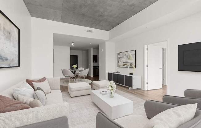 A living room with a grey couch and a coffee table.