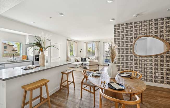 a living room with a kitchen and a dining table