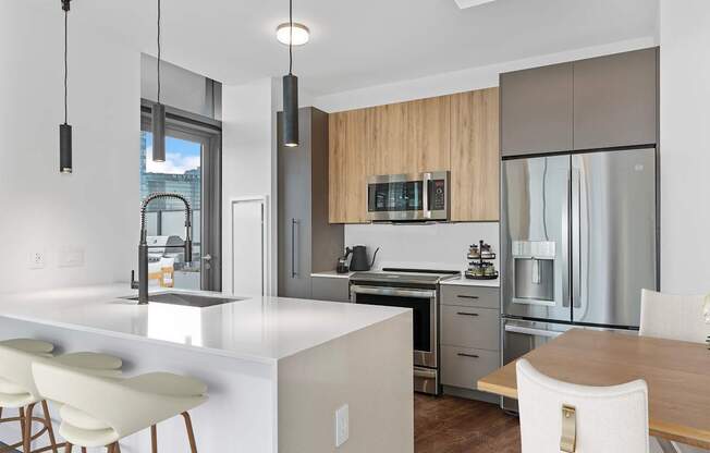 a kitchen with a large island and a table with chairs at Cassidy on Canal, Chicago, Illinois, 60606