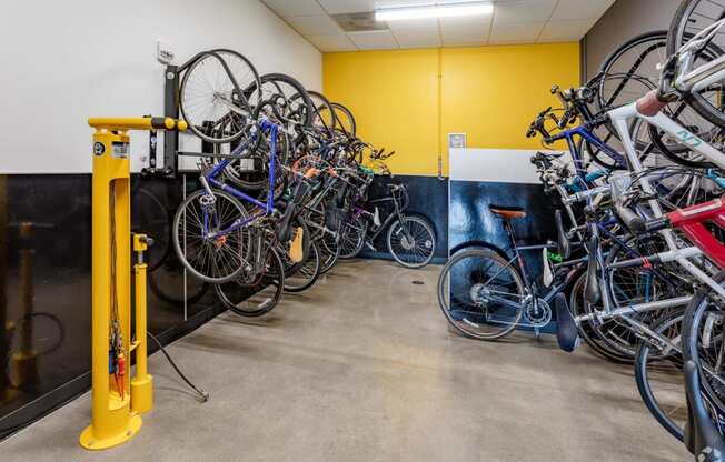 a group of bikes hanging on a wall in a room