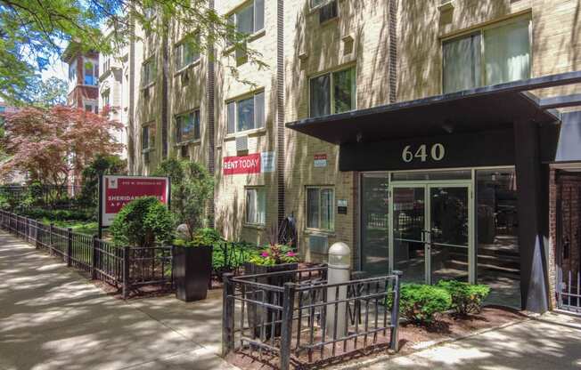 an apartment building with a large entrance and a sign that says 6410