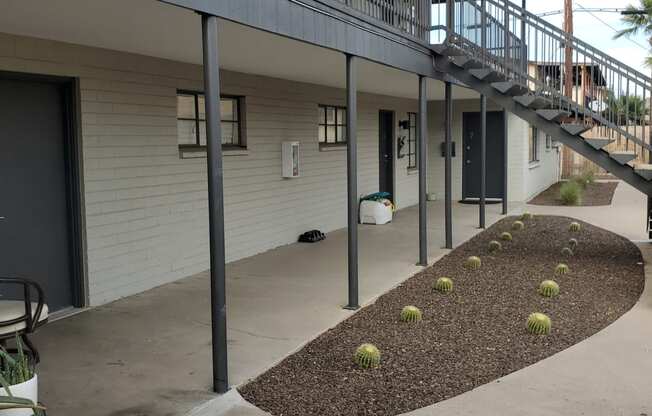 an outside view of a building with stairs and plants