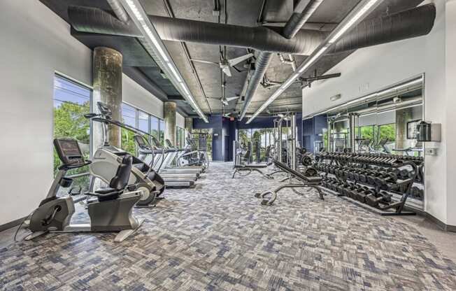 State-of-the-art fitness center with a variety of exercise equipment at Allusion at West University apartments in Houston, TX