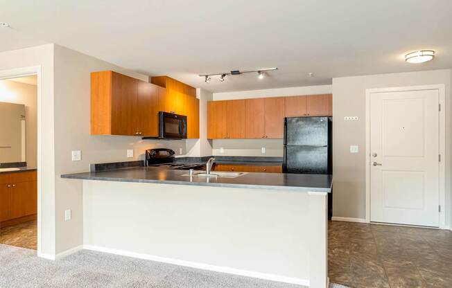 A kitchen with a white island and wooden cabinets.