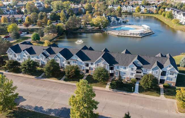 A row of houses with a lake and a boat docked in front.