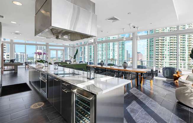 Sky-Lounge kitchen with a long counter and a view of the city.