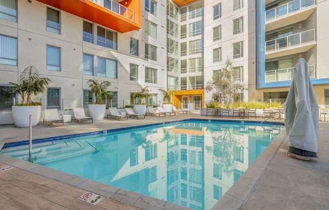 a swimming pool in front of an apartment building