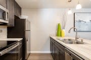 A kitchen with a sink and refrigerator