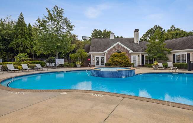 a swimming pool with a house in the background