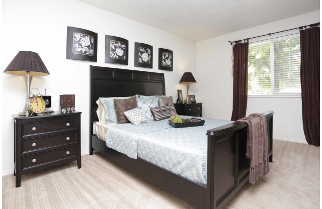 Master bedroom with queen bed, 2 nightstands, and one large window