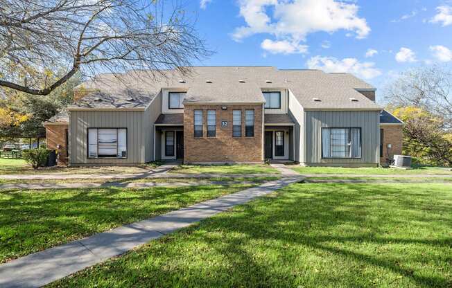A house with a grey roof and a brick facade.