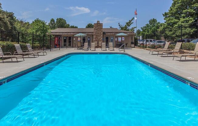Swimming pool with lounge seating at Bristol Pointe Apartments in Olathe, Kansas.