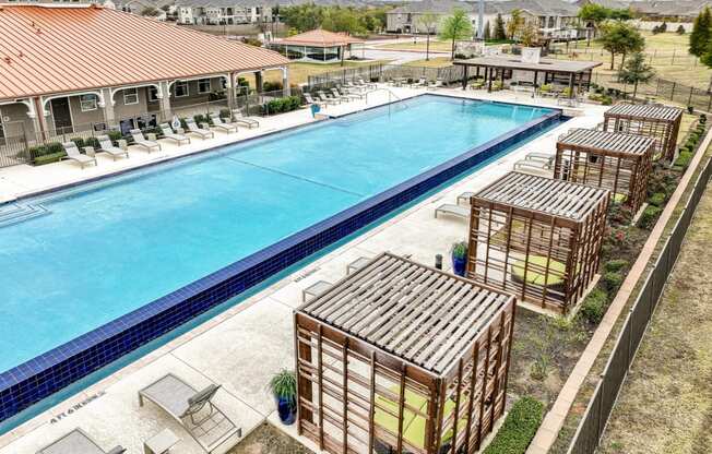 resort-inspired swimming pool with cabana lounging areas at Villages 3Eighty apartments