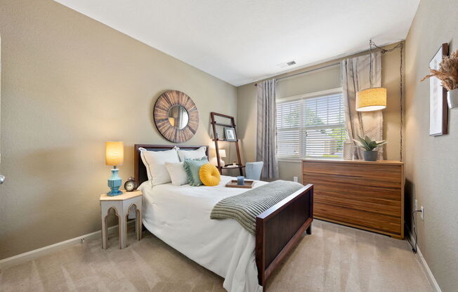 spacious bedroom with model decor and large window in Fenwyck Manor Apartment home