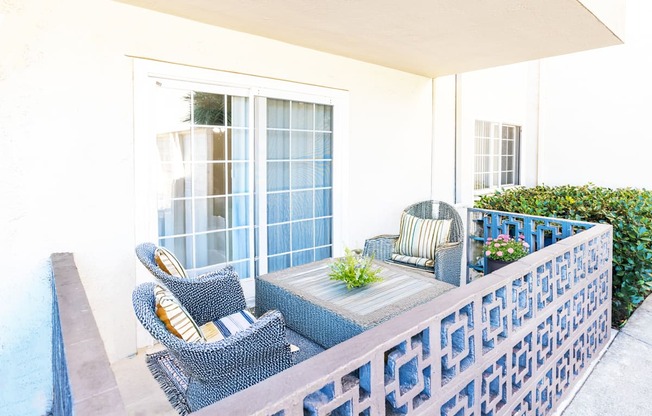 A patio with a table and chairs.