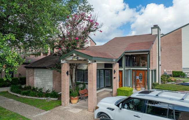 A house with a car parked in front.