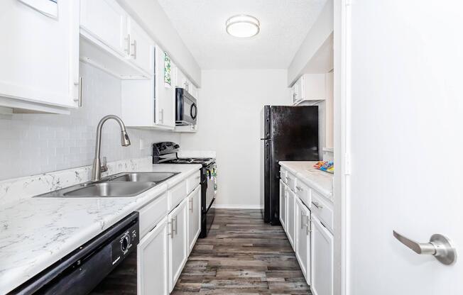 a kitchen with a stove and a sink