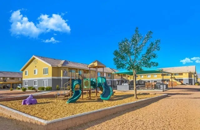 Apartments for Rent in North Las Vegas, NV - Portola Del Sol - Playground Area with Wood Chips, Slides, and Landscaping