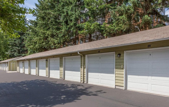 a row of garages in a row with trees in the background