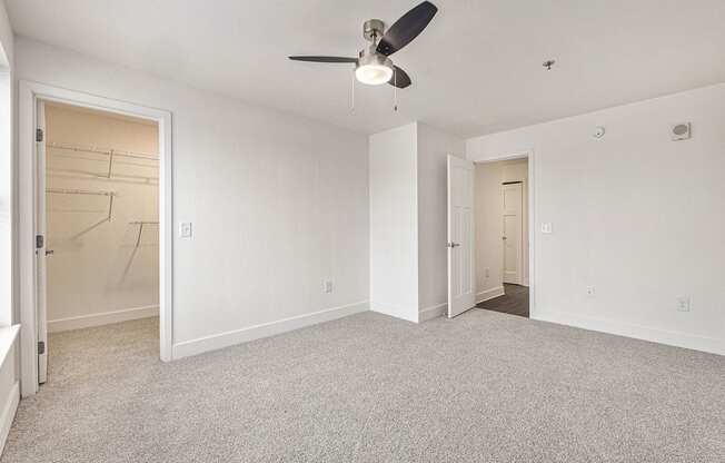 Large bedroom with a ceiling fan and a walk in closet  at Signature Pointe Apartment Homes, Alabama, 35611